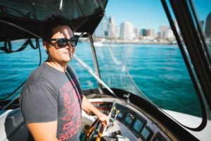 Athan at Helm of San Diego Yacht Charter