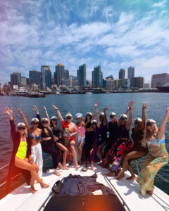 People in yacht bow  raising their hands in the air