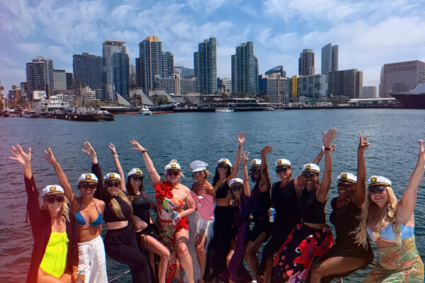 People in yacht bow raising their hands in the air