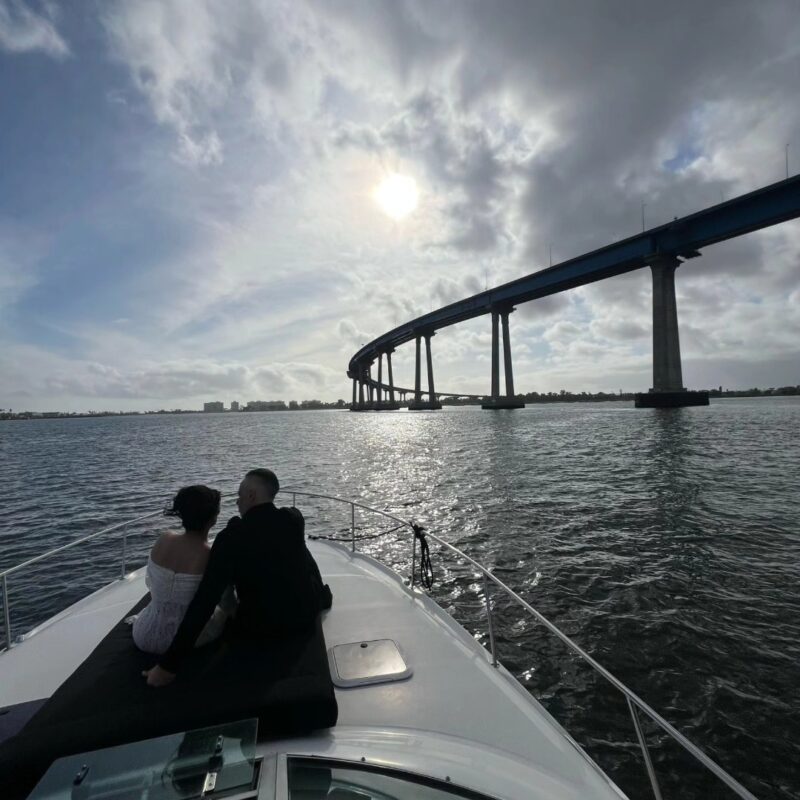 Couple enjoying wedding yacht charters San Diego on a private yacht with scenic views of the Coronado Bridge and San Diego Bay.